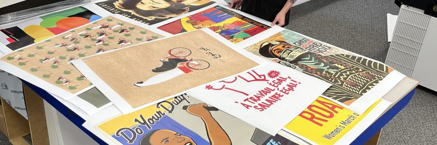 posters-on-table » Poster Ninja many custom printed posters on tabletop